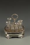 A GEORGE VI CRUET STAND of oval form, with a gadrooned border, crested with a central loop carrying