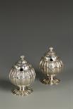 A PAIR OF GEORGE IV SUGAR VASES AND COVERS of pineapple form, the fluted pull off covers with