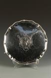 A GEORGE III SALVER of shaped circular form with a gadrooned border, centred with an engraved