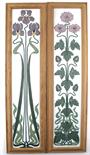 A pair of Art Nouveau enamelled glass panels, painted with flag iris and anemone flower stems in