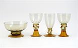 A pair of James Powell & Sons Whitefriars amber glass goblets, with applied prunt and rigoree band