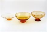 Two James Powell & Sons Whitefriars amber glass Lotus bowls, modelled in stages of the flower