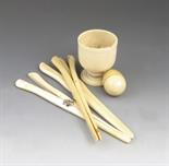 ?  A 19th century turned ivory cup, 7.4 cm high, an ivory egg with a screw off cover, possibly