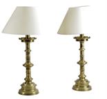 A pair of Victorian brass Gothic style candlesticks in the manner of Pugin, each with pierced