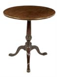 A mahogany tripod table, the circular tilt-top on a turned stem and cabriole legs to pad feet,