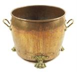A late 19th century Dutch copper and brass log bin, with side handles and paw feet, 35.2cm high,