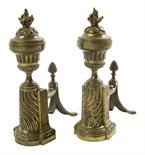 A pair of George III gilt bronze andirons, each with an urn above a spiral fluted base with a fir