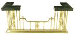 A brass club fender, the green leather studded seats to a railed front, 60cm high, 141.7cm wide,