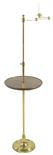 A brass standard lamp, with an extending arm and adjustable mahogany shelf, 143.3cm high (