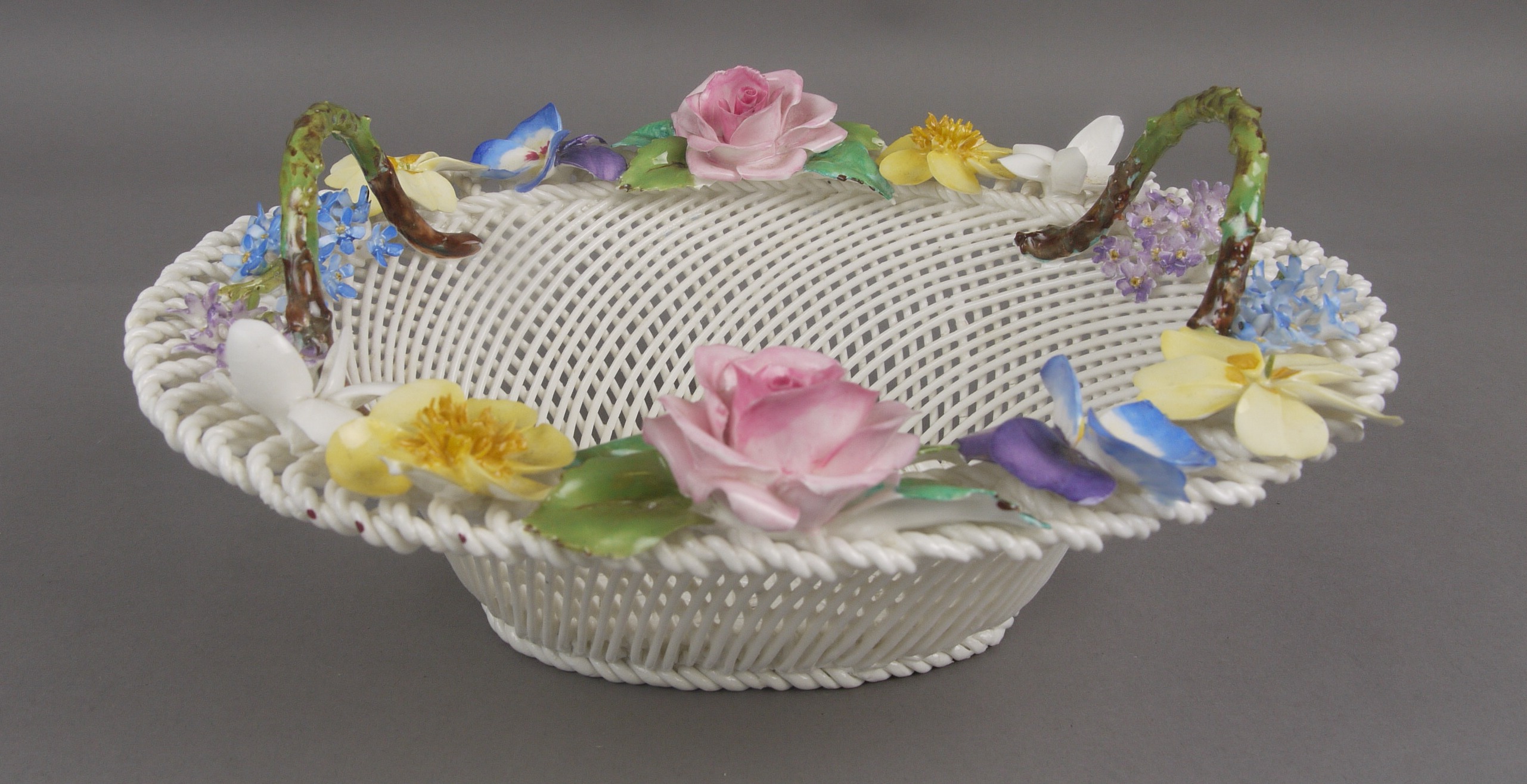 A CROWN STAFFORDSHIRE BONE CHINA SWEETMEAT BASKET, with lattice sides and four strand woven base,