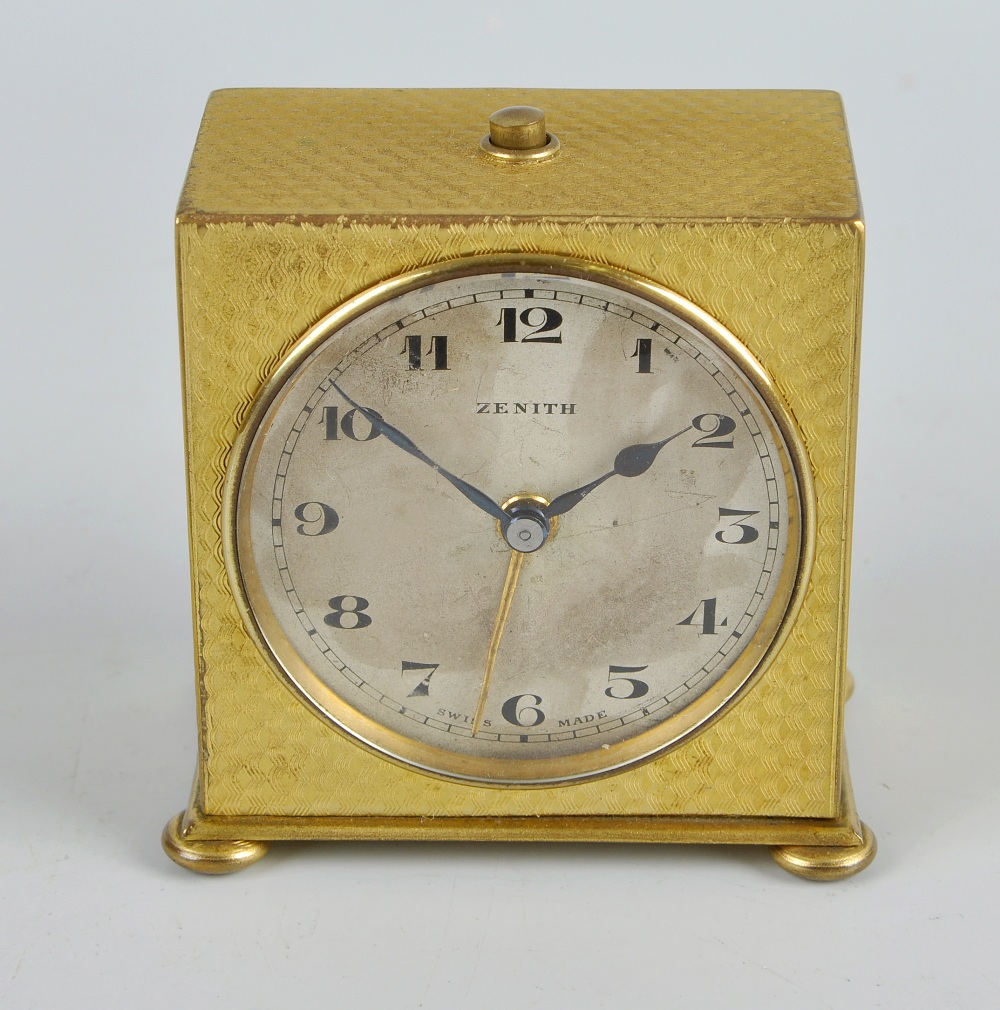 A Zenith travel alarm clock. With circular Arabic dial, the backwound movement numbered 91053,