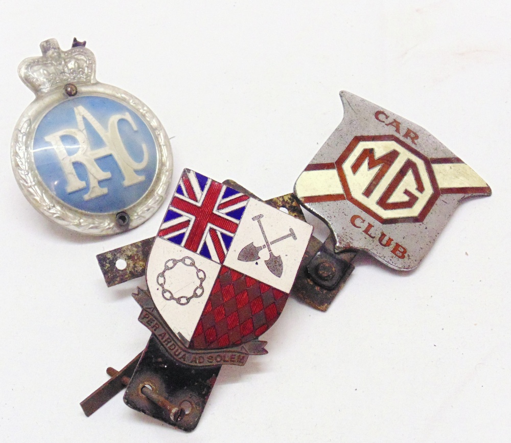 Three vintage car badges comprising RAC, MG car club and rally drivers