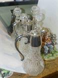 Pair of cut glass claret jugs, four decanters, two Capodimonte groups and silver plated ware