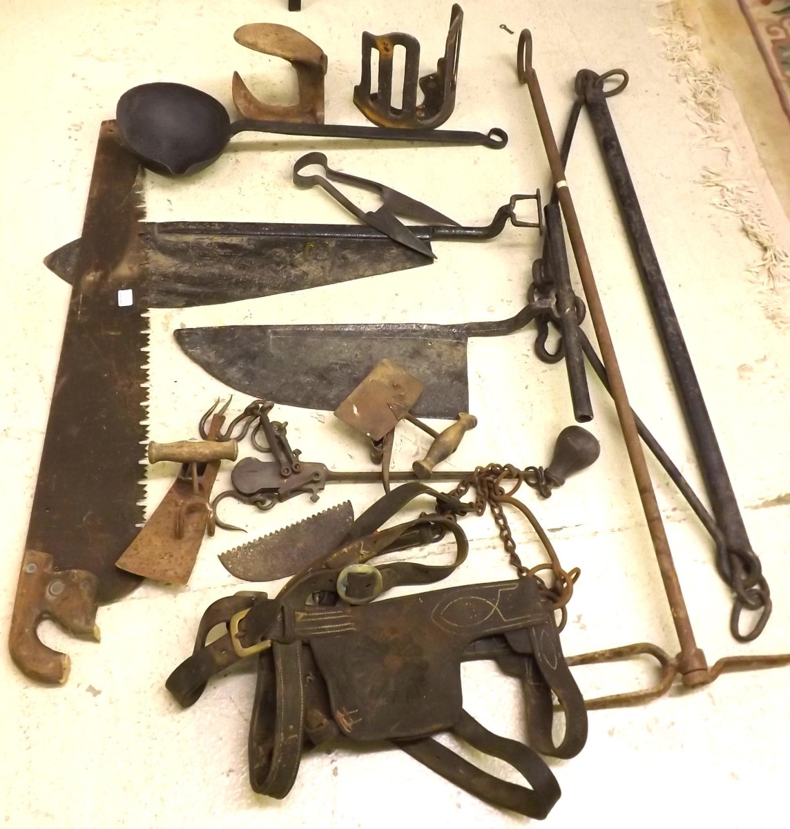 Antique farm tools and traps; together with an antique cast iron ladle