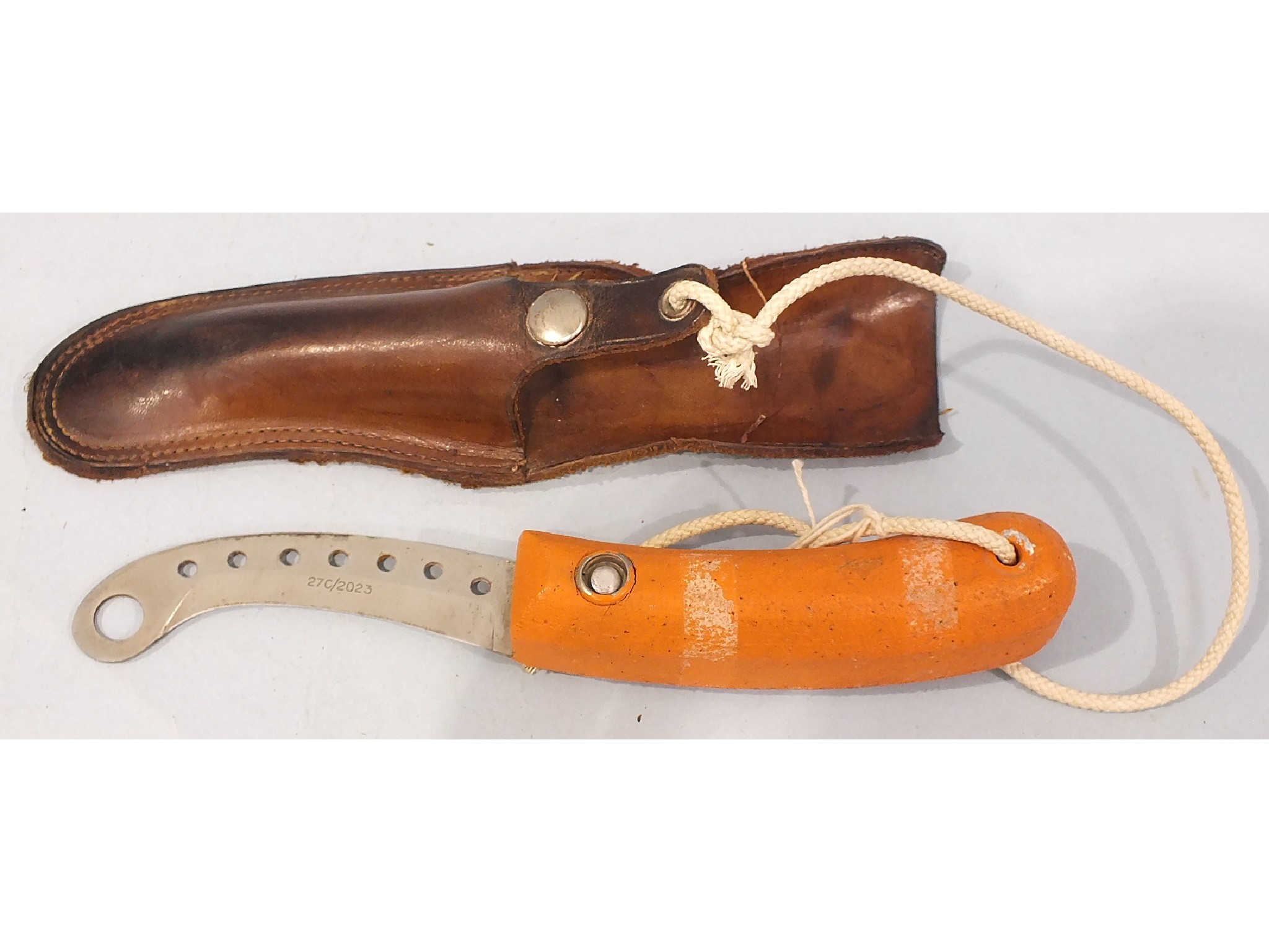 A WWII RAF dinghy knife, the blade marked 27C/2023, in leather scabbard.