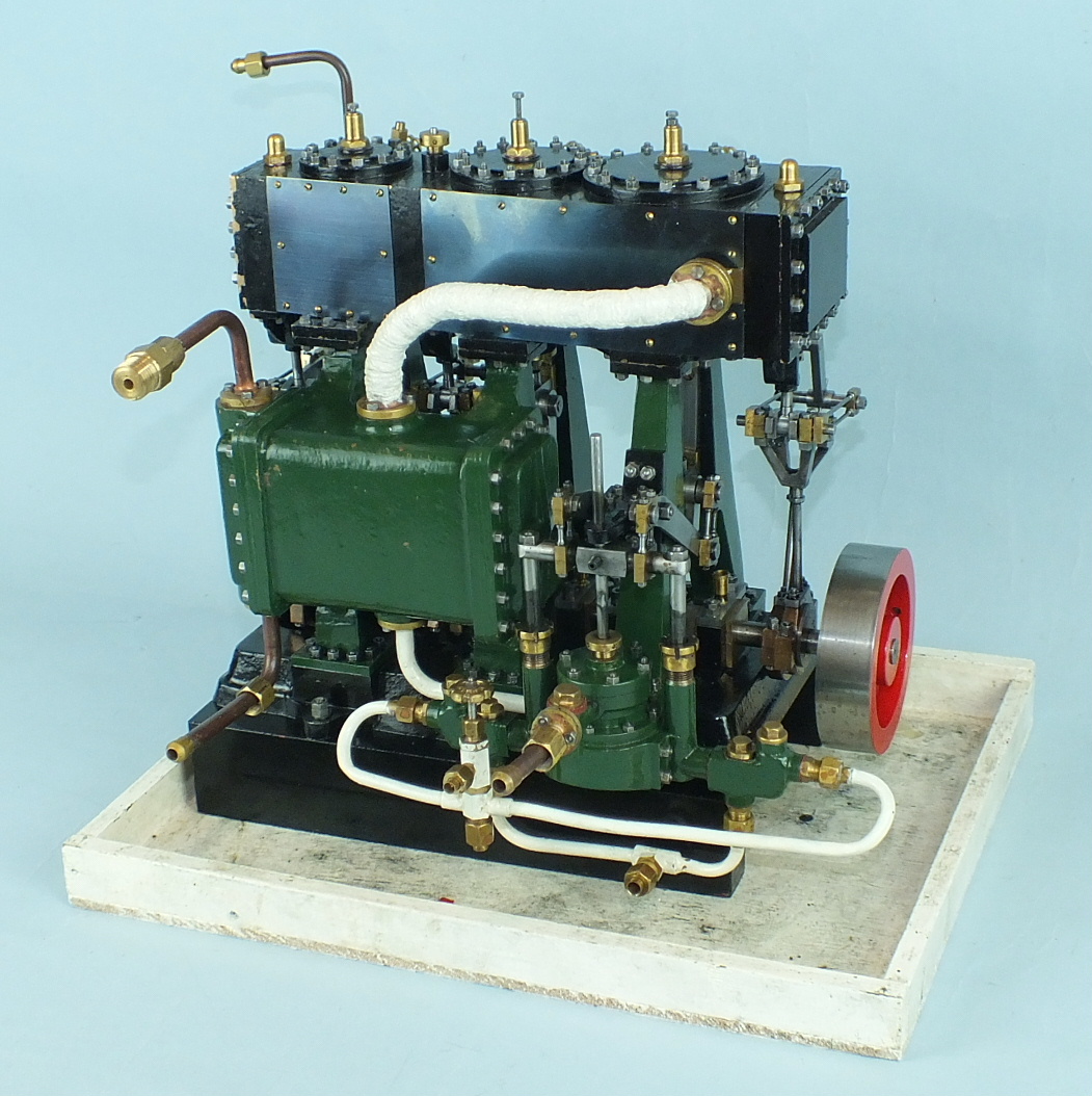 A live steam model of a triple expansion marine engine finished green