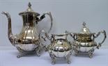 A plated coffee pot, sugar bowl and a cream jug