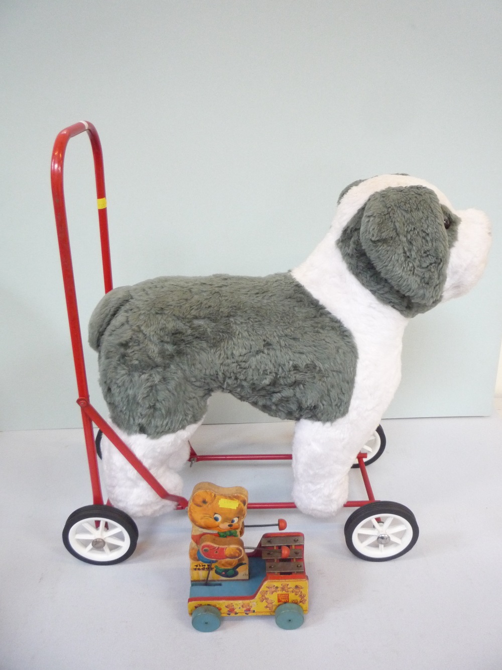 A VINTAGE NYLENA PUSH ALONG DOG, with a Fisher Price `Tiny Teddy` pull