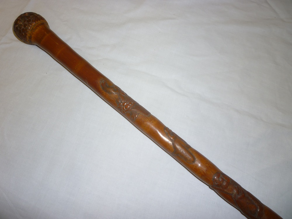 An unusual Japanese "Whangee" carved bamboo walking cane decorated with