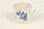 Eighteenth century Worcester fluted coffee cup painted in dry blue with floral sprigs, gilded border