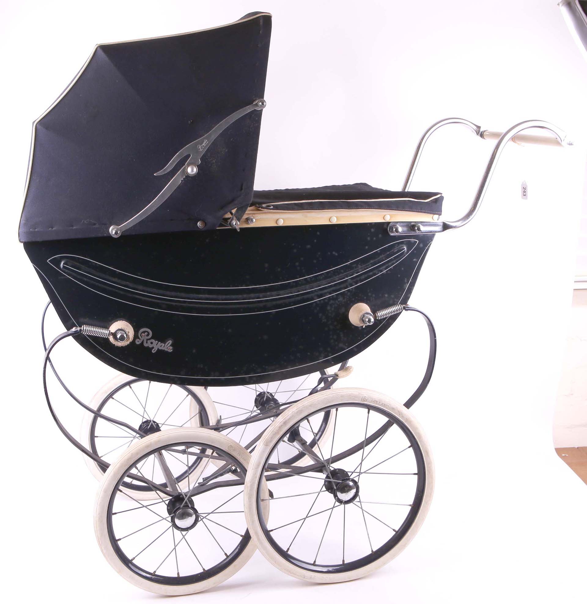 A child`s dolls Royale 1960s pram, in navy blue with rain cover and