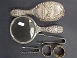 Miscellaneous silver to include a dressing table mirror and brush, 2 napkin rings and 2 sugar tongs.