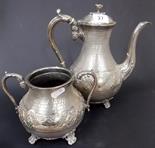 Silver plated engine turned and embossed hot water pot and Sucrier, upon quadruple scroll feet.