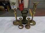 A pair of turned brass candlesticks, a pair of brass taper sticks and a bell-shaped weight.