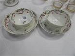 Pair of early 19th Century New Hall tea bowls and saucers painted in enamels in famille rose pallets