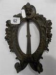 Bronze oval easel picture frame, cast with leafy scrolls and flower garlands surmounted by a