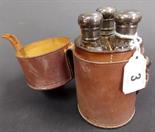 Edwardian three bottle travelling set in tan leather case, the triangular section bottles with screw