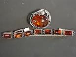 Silver Arts and Crafts style amber brooch together with a silver amber set bracelet.