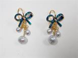 Pair of yellow metal and enamel bow earrings, each with three fresh water pearl drops.