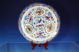 A Bristol Delft polychrome charger mid-18th century, painted in blue, red and green with a central