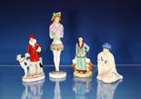 An Art Deco porcelain pin cushion lady in period clothing with pin-cushion waist section on circular