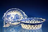 A pair of early 19th century pearlware chestnut baskets of typical flared oval form, with diamond