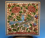 An Iznik ceramic tile probably 18th century, polychrome decoration depicting birds amongst flowering