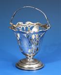 A small Edwardian silver swing handled sugar basket Charles Edwards, London 1908, of inverted bell