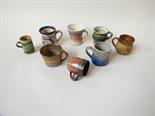 A collection of studio pottery small mugs, various makers including Sylvia Dales