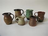 A collection of small studio pottery jugs including Muchelney , John Solly and a Ray Finch mug