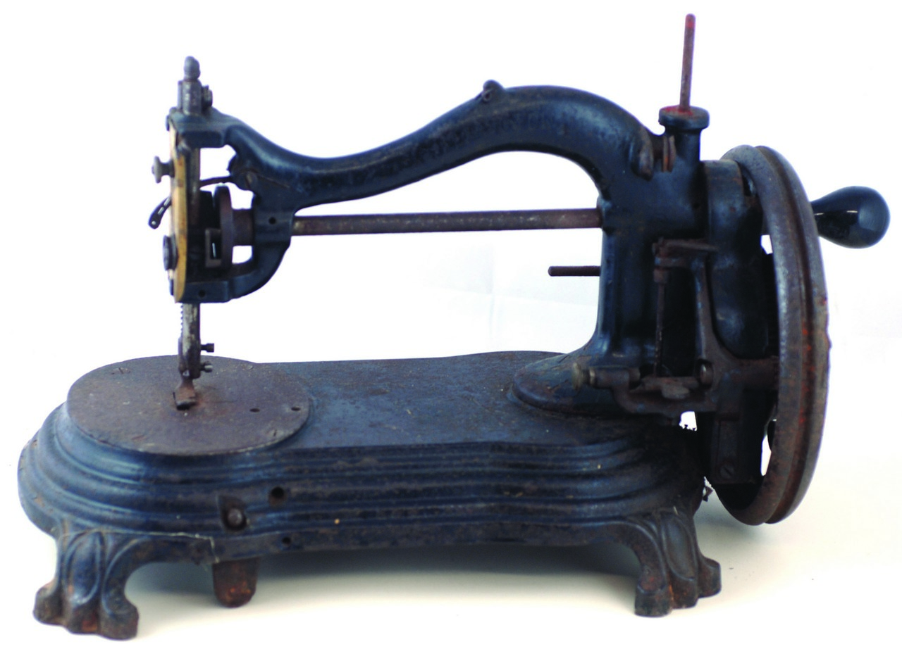 CAST IRON SEWING MACHINE. 10ins tall, cast iron sewing machine on paw