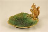 Minton majolica nut dish, circa 1872, overlapping leaf form surmounted with a squirrel holding a