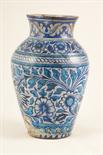 Persian blue glazed terracotta vase, ovoid form decorated with scrolling flowers and foliage,