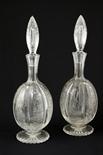 Pair of Stourbridge `rock crystal` engraved glass decanters, ovoid form finely engraved with panels