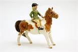 Beswick figure of a girl on a skewbald pony, model no. 1499, designed by A Gredington, issued