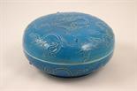 Chinese blue glazed covered bowl, relief decorated throughout with scrolling dragons chasing flaming