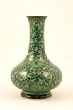 Chinese green glazed bottle vase, baluster form with trumpet neck, decorated with stylised lotus