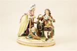 German porcelain figure group, modelled as a family conversation piece, decorated in colours on a