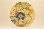 Grays Pottery plaque, decorated with stylised flowers in colours against a straw ground, printed