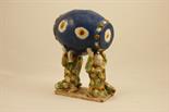 Chinese Tang style table ornament, modelled as kneeling strong men holding a barrel above their